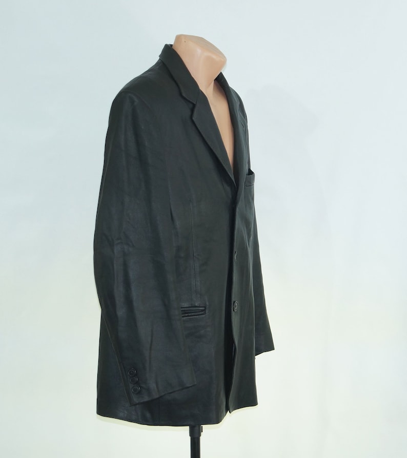 May include: A black leather blazer with a single button closure and two pockets.
