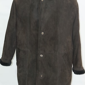 May include: A brown suede shearling coat with a black fur collar and four button closures.