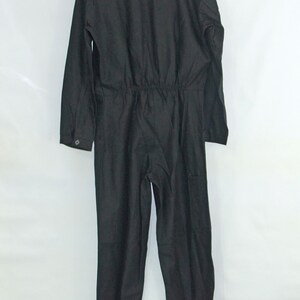 May include: A black jumpsuit with long sleeves and a drawstring waist.