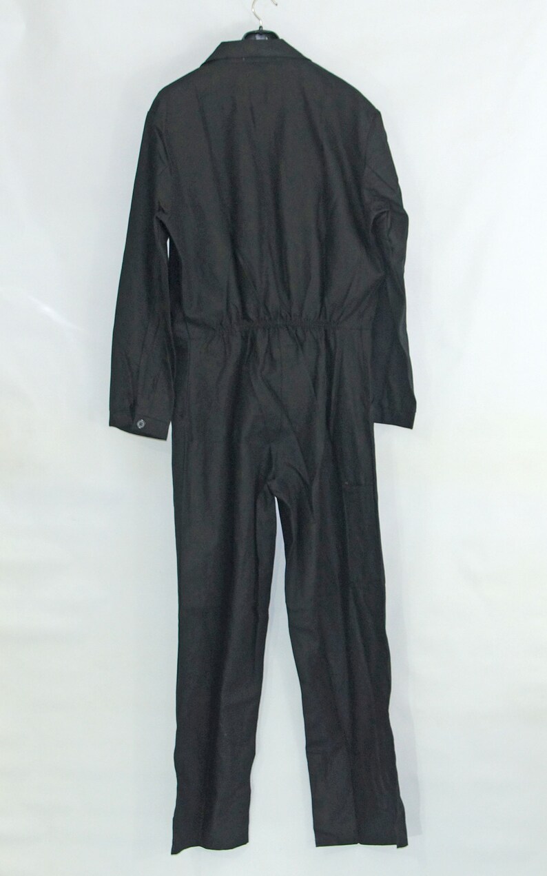 May include: A black jumpsuit with long sleeves and a drawstring waist.