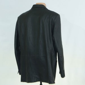 May include: A black leather blazer with a classic design. The blazer has a single-breasted closure, a notched lapel, and two front pockets.