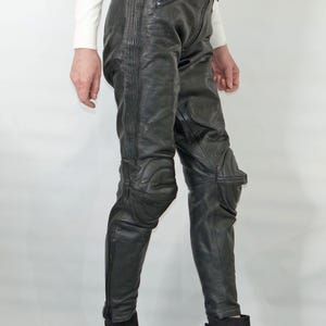 Vintage motorcycle black leather pants with knee soft protection, marked size 48