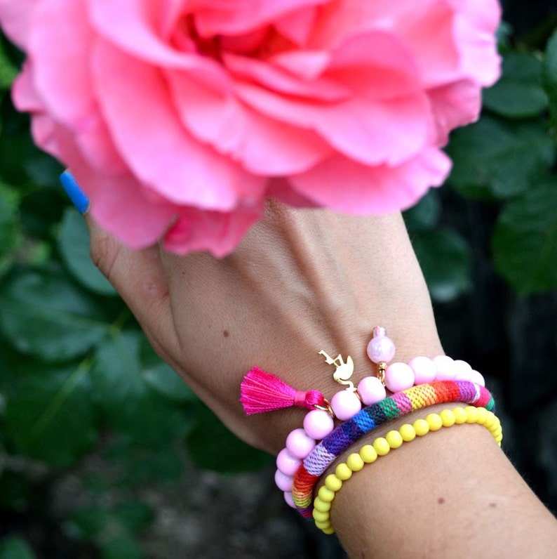 A set of 3 colourful bracelet with flamingo charm and tassel
