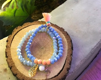 A set of 2 beaded bracelets with pineapple, flamingo charms and tassel.