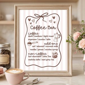 May include: A framed sign with a light pink and white striped background featuring the text Coffee Bar, listing coffee, add-ons, and non-coffee options with small illustrations of a moka pot and a carafe, all enclosed in a brown decorative border.
