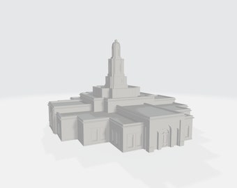 May include: A white, detailed model of a temple with a tall spire and multiple windows.