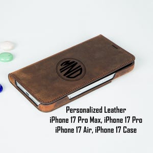May include: A brown leather phone case with a personalized monogram. The case is designed for iPhone 17 Pro Max, Pro, Air, and Case models. The text "Personalized Leather" is displayed below the case.