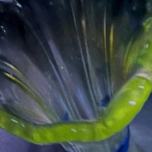 Vaseline glass clear tall thin vase pressed etching bottom and edges. scalloped wavy top