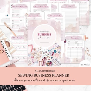 May include: A pink and white sewing business planner with various forms, including a to-do list, cost tracker, and product inventory. The planner includes the text "Sewing Business Planner" and "Management and finance forms". A magazine and pen are also visible.