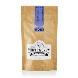 May include: A brown paper pouch with a blue label that says "Fruit Blend Blue Moon Blueberry Cream Taste" and "Nº23". The label also has a black and white illustration of a cat and the text "The Tea Crew Premium Loose Leaf There's No Business Like Tea Business".