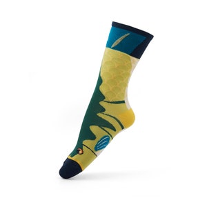 May include: A pair of colorful socks with a green, yellow, and blue pattern. The socks feature a fish design with scales and fins.