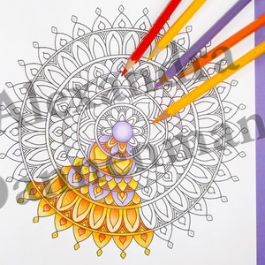 May include: A black and white mandala design with intricate details. The mandala is partially colored in shades of yellow, orange, and purple. The image shows colored pencils on a purple background.
