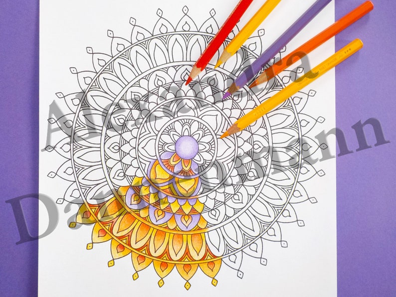 May include: A black and white mandala design with intricate details. The mandala is partially colored in shades of yellow, orange, and purple. The image shows colored pencils on a purple background.