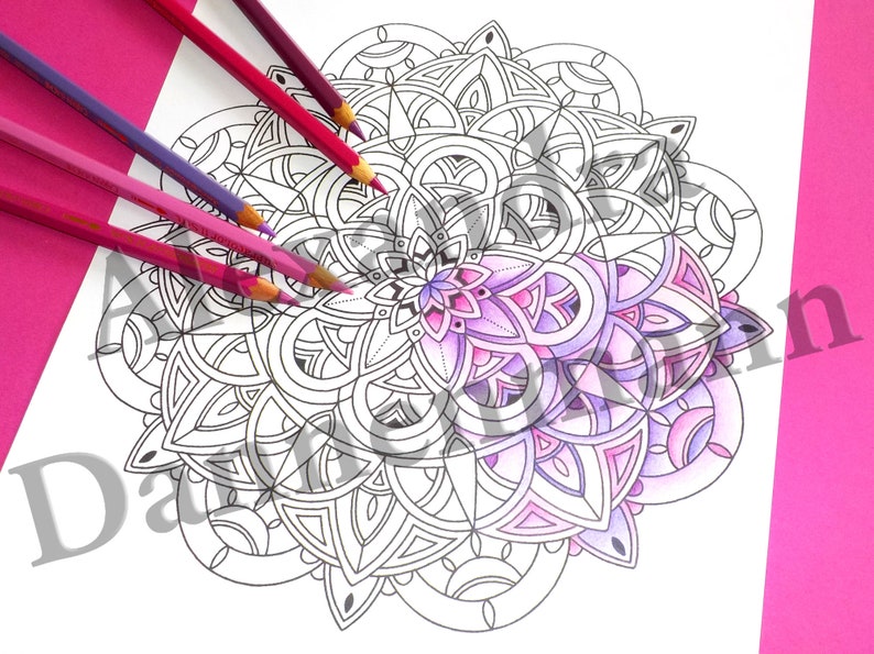 May include: A black and white mandala coloring page with a portion of the design colored in shades of pink and purple. The mandala is surrounded by colored pencils.