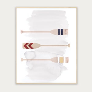 May include: Three watercolor painted wooden oars with different colored stripes on a white background. The oars are arranged vertically with the top oar having blue and white stripes, the middle oar having red and white stripes, and the bottom oar having gold and white stripes.