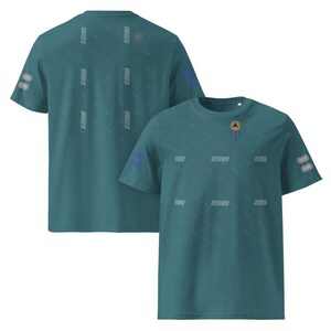May include: Teal-colored t-shirts with a crew neck and short sleeves. The shirts feature a repeating pattern of text and small shapes, with a circular design on the back and a small emblem on the front.