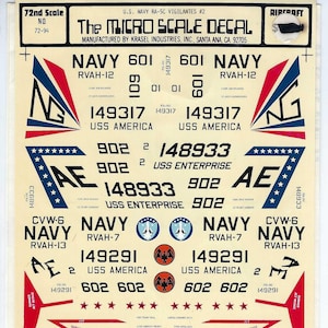 May include: A sheet of Micro Scale Decals for U.S. Navy RA-5C Vigilantes aircraft. The decal sheet features various markings, including NAVY, numbers, and insignia. The sheet is labeled "72nd Scale" and includes text such as "USS America" and "USS Enterprise."