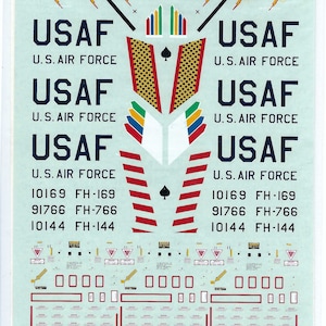 May include: A decal sheet for a 1/72 scale model of a USAF F-105D Thunderchief. The sheet includes markings for the aircraft, including the USAF logo, tail numbers, and other details. The sheet is printed on clear plastic and is designed to be applied to the model.