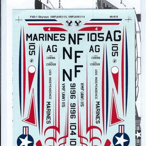 May include: Decal sheet for an F4D-1 Skyray aircraft, with red, white, and blue markings. The decals include text such as "MARINES", "USS INDEPENDENCE", and various numbers and codes. Designed for VMF(AW)115 and VMF(AW)114.