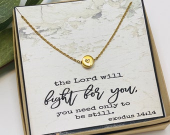 May include: Gold necklace with a small heart charm and a card that reads "the Lord will fight for you. you need only to be still. exodus 14:14"