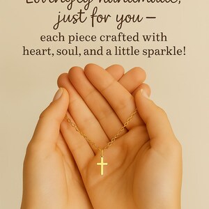 May include: A gold-coloured necklace with a small cross pendant. The text above reads: Lovingly handmade, just for you - each piece crafted with heart, soul, and a little sparkle! The chain features delicate links and a simple cross charm.