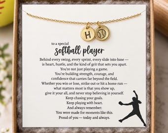 May include: A gold-coloured chain necklace featuring two small circular charms, one engraved with the letter H and the other with a softball design, presented on a card with the text to a special softball player and a silhouette of a player.