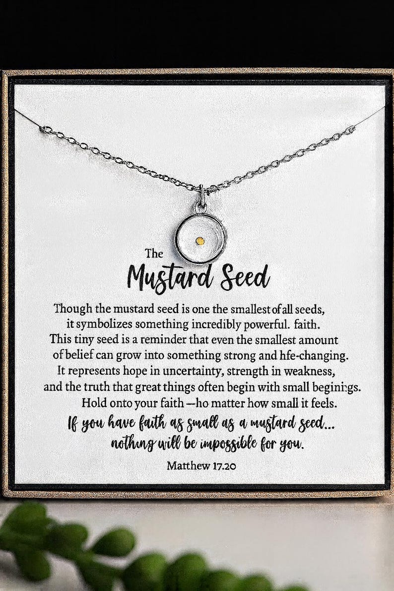 May include: Silver-toned necklace with a circular pendant containing a mustard seed. The pendant hangs from a delicate chain. The card behind the necklace has text that reads "The Mustard Seed" and a quote from Matthew 17:20.