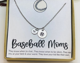 May include: A silver necklace with two pendants, one round with a baseball design and the other small and round with a heart. The necklace is presented in a gift box with the words "Baseball Moms".