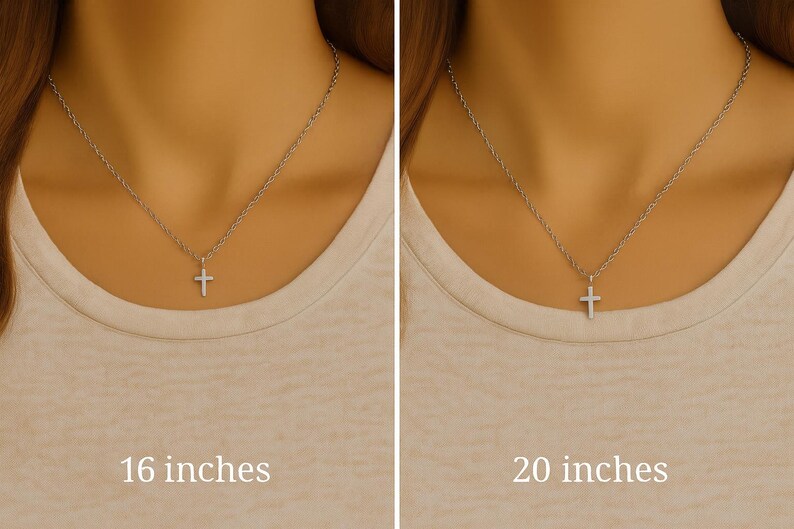 May include: A silver-toned cross pendant on a delicate chain, shown in two lengths: 16 inches on the left and 20 inches on the right. The cross is simple and metallic, suspended from a thin, reflective chain that rests against a neutral-colored top.