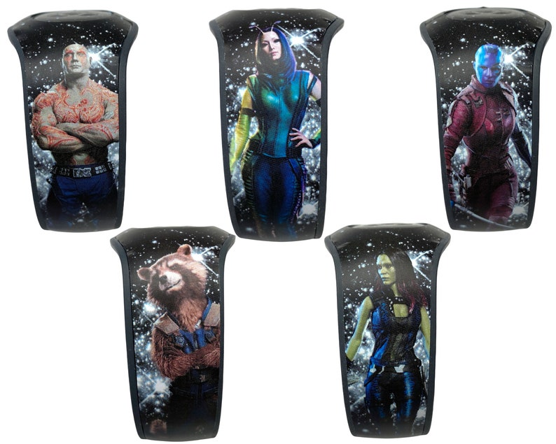 May include: Five different black wristbands with a space background and a character from the Guardians of the Galaxy movie series. The characters are: Drax, Gamora, Nebula, Rocket, and Mantis.