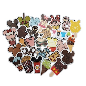 May include: A collection of colourful Disney-themed stickers featuring Mickey Mouse, Minnie Mouse, and other characters. The stickers depict various foods and treats, including ice cream, popcorn, doughnuts, and cupcakes.