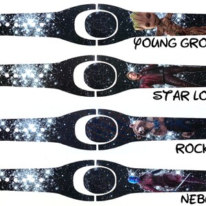 May include: Four different designs for a Disney MagicBand featuring characters from Guardians of the Galaxy. The designs feature a black background with a galaxy pattern and a white outline of Mickey Mouse's head. The characters featured are Young Groot, Star-Lord, Rocket, and Nebula.