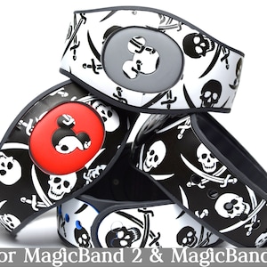 May include: Four black and white MagicBand 2 and MagicBand+ wristbands with a skull and crossbones pattern. Each band has a different colored Mickey Mouse icon.