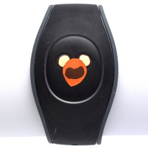 May include: Black MagicBand with a brown and orange Mickey Mouse head design.