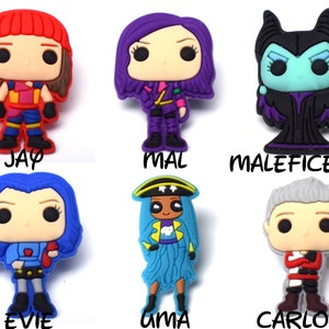 May include: Six colorful cartoon character figurines with large eyes and a pop art style. The characters are from the Disney Descendants movie franchise. The characters are Jay, Mal, Maleficent, Evie, Uma, and Carlos.