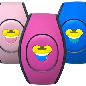 May include: Three pink, blue, and purple MagicBands with a Mickey Mouse head wearing a crown and a face mask. The face mask is a different color on each MagicBand.