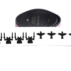 May include: A black and white sticker sheet with a row of five black silhouettes of a creature with wings and a row of five black silhouettes of a creature with candles.
