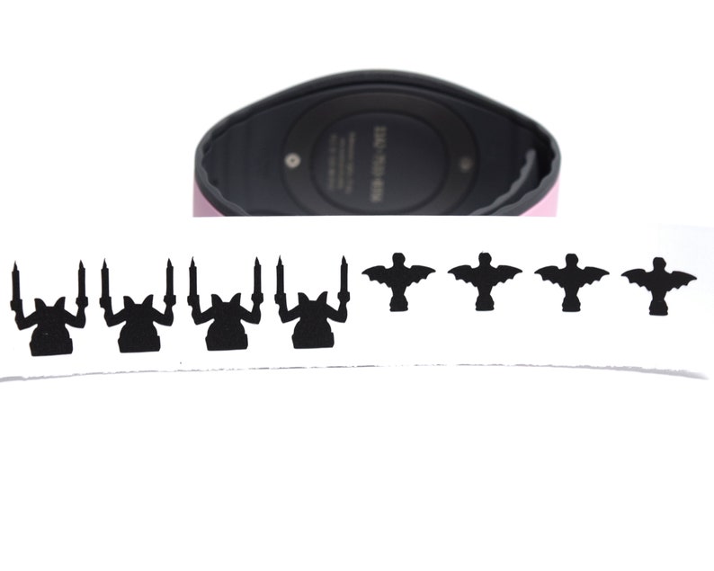 May include: A black and white sticker sheet with a row of five black silhouettes of a creature with wings and a row of five black silhouettes of a creature with candles.