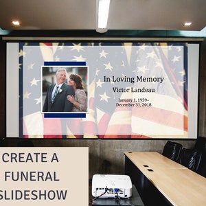 May include: A projector screen displaying a slideshow for a funeral. The screen shows a photo of a couple, an American flag background, and the text "In Loving Memory Victor Landeau January 1, 1959- December 31, 2018".