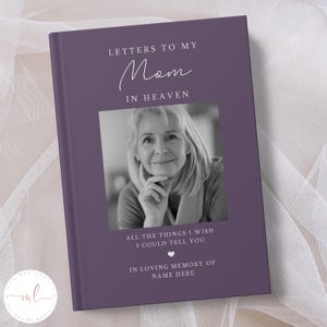 Op de afbeelding: Een paars dagboek met de tekst "Brieven aan mijn moeder in de hemel" en een zwart-witfoto van een vrouw. Onder de foto staat de tekst "Alle dingen die ik je wil vertellen" en een klein hartje. De tekst "Ter nagedachtenis aan Naam hier" staat onderaan het dagboek.