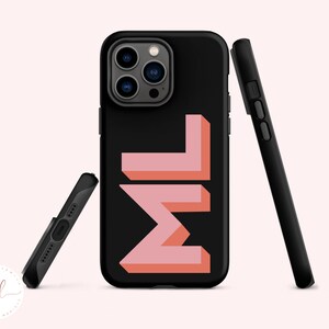 May include: Black phone case with a pink and orange "ML" design.