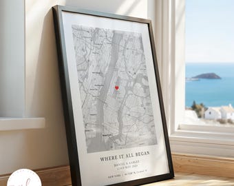 May include: A framed map print of New York City in shades of gray with a small red heart marking a specific location. The text reads WHERE IT ALL BEGAN, DANIEL & KARLEE, 23RD MAY 2024, and NEW YORK | 40.7128° N, 74.0060° W in a black frame.