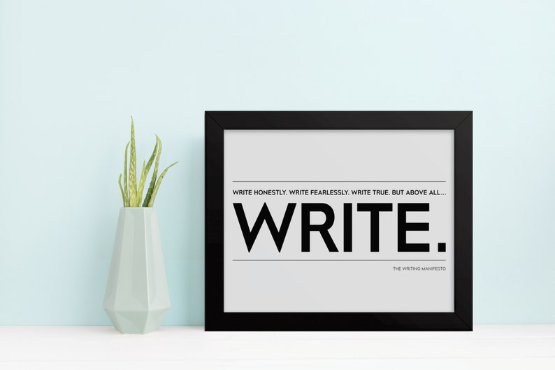 May include: Black framed print with a white background and the text "WRITE HONESTLY. WRITE FEARLESSLY. WRITE TRUE. BUT ABOVE ALL... WRITE." and "THE WRITING MANIFESTO" in smaller font below.