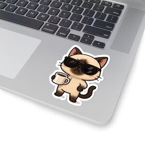 May include: A cartoon illustration of a cat wearing sunglasses and holding a cup of coffee. The cat is brown and white with a grumpy expression.