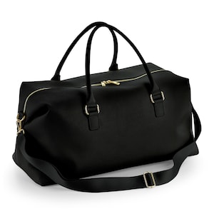 May include: Black leather duffel bag with gold hardware and a long adjustable strap.