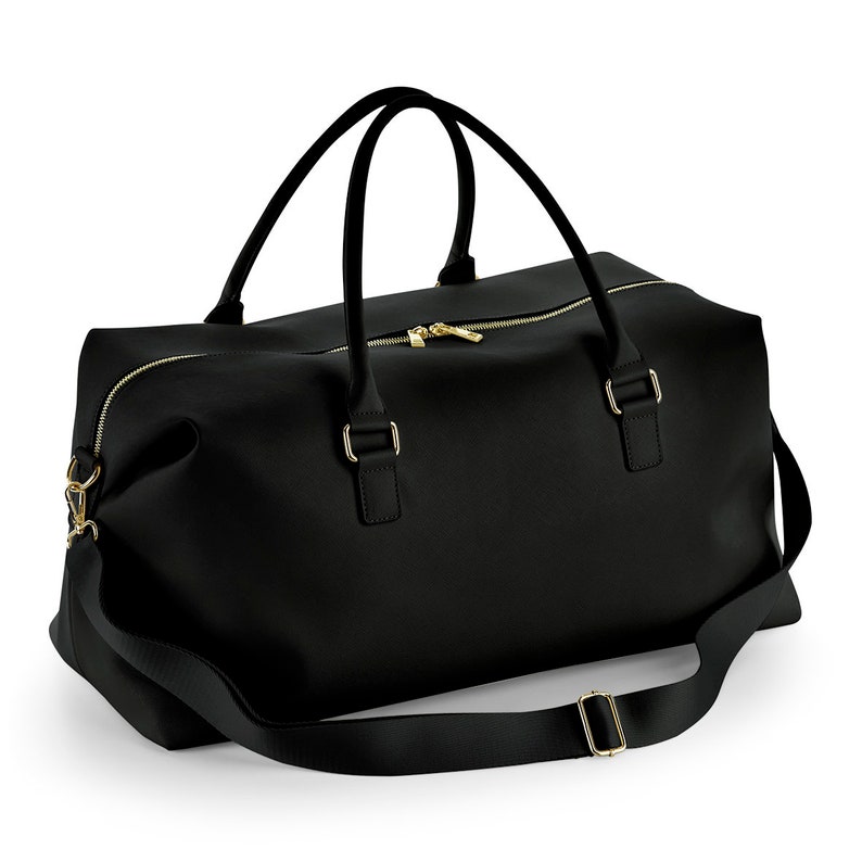 May include: Black leather duffel bag with gold hardware and a long adjustable strap.