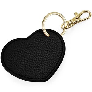 May include: A black heart-shaped leather keychain with a gold metal ring and clasp.
