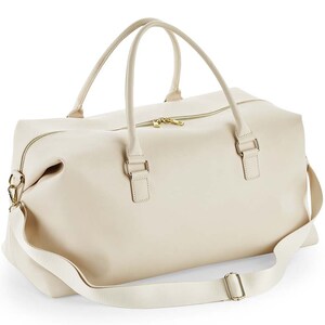 May include: A cream-colored leather weekender bag with a top zipper closure, two top handles, and a detachable shoulder strap.