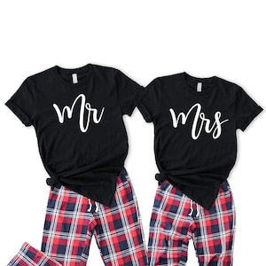 May include: A matching set of black t-shirts with white text, one saying "Mr." and the other saying "Mrs." The shirts are paired with red and blue plaid pajama pants.