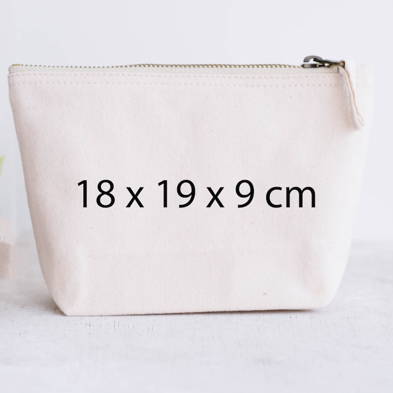 May include: A white canvas zippered pouch with the dimensions 18 x 19 x 9 cm printed on the front.